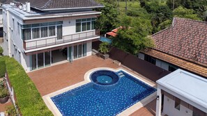 A modern two-story house with a swimming pool, surrounded by a well-maintained garden and a neighboring building. - Private Pool Villa Chalong (Chalong)