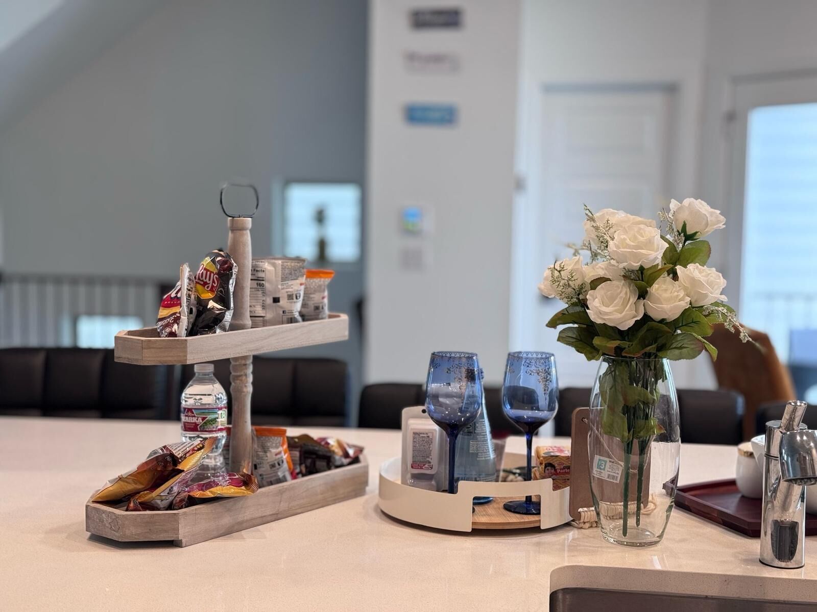 Un hall d’hôtel avec un buffet, un vase de fleurs blanches et un coin salon à l’arrière-plan.