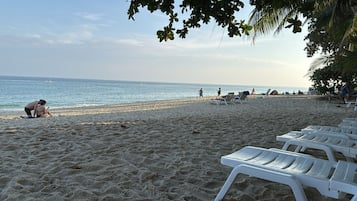 On the beach, sun loungers, beach towels