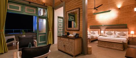 A cozy room with a wooden ceiling, a bed with white linens, a nightstand, a dresser, and a chair.
