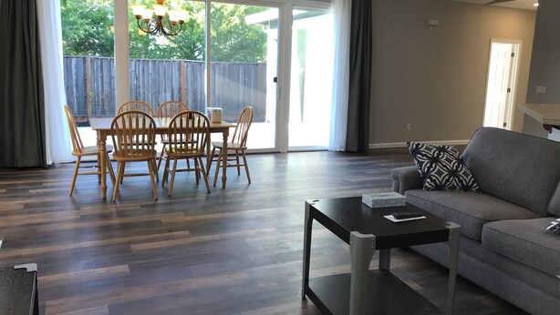 A spacious living room with a dining area, a gray sofa, and a modern coffee table. - Charming 3-bedroom house with AC and WiFi in Santa Rosa (Santa Rosa)