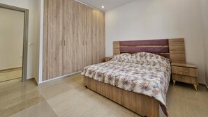 A bedroom with a bed, a wardrobe, and a nightstand. - Charming villa on the dream island of Djerba (Tunis)