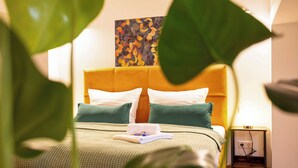 A neatly made bed with a green and white checkered bedspread, two pillows, and a folded towel on the side. - Soulscape Apartment CityCenter - compact & luxurious loft apartment in the city center (Zwickau)