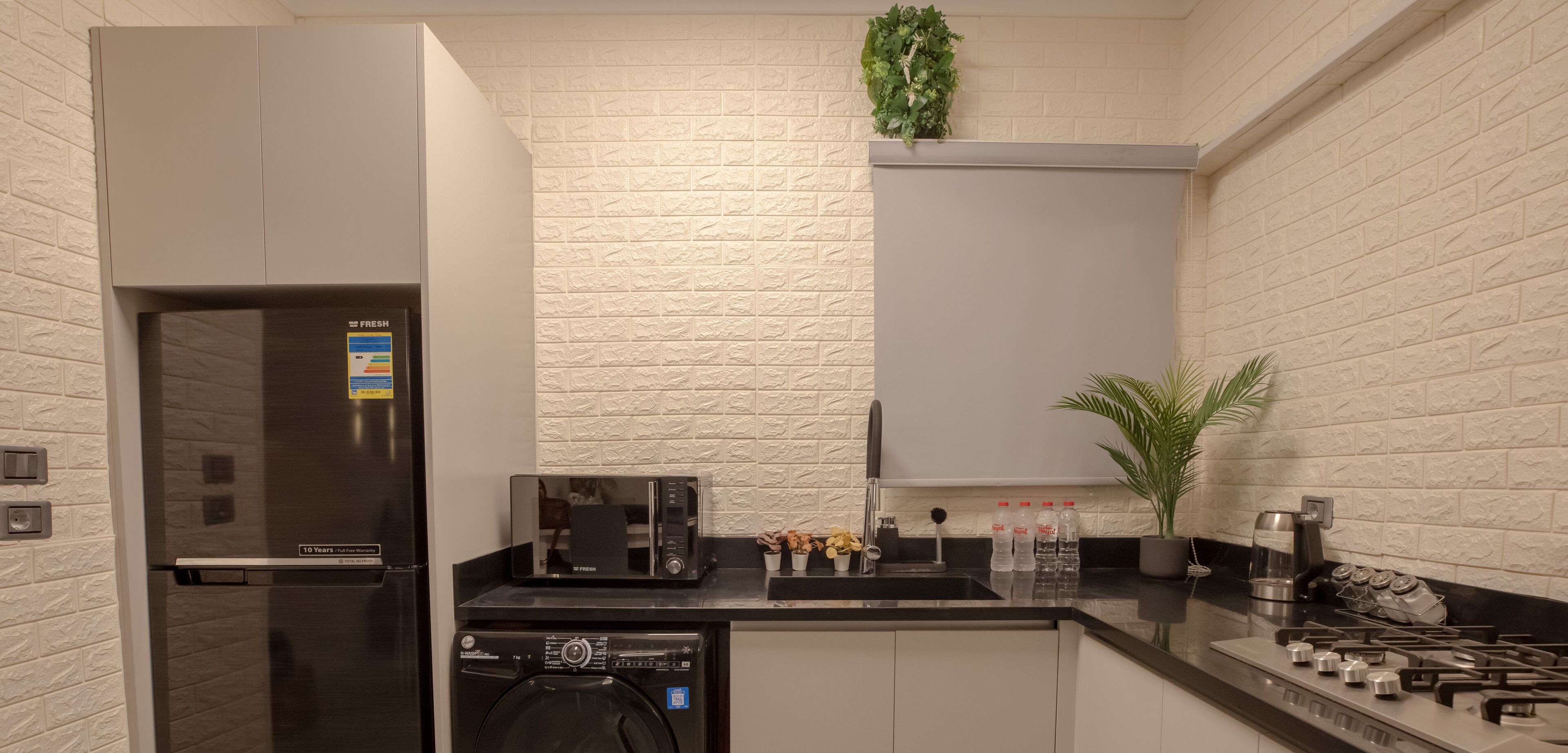 A modern kitchen with a built-in dishwasher, a microwave, and a gas stove.