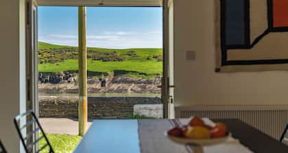 A pretty cottage by the sea, with uplifting views and lively Kinsale nearby.