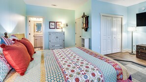 A bedroom with a large bed, a dresser, a wardrobe, and a mirror. - Dock & Fire Pit: Waterfront Midway Retreat! (Midway)