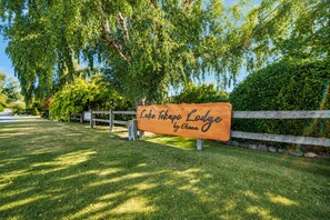 A wooden sign for Lake Tahoe Lodge by Ohana.