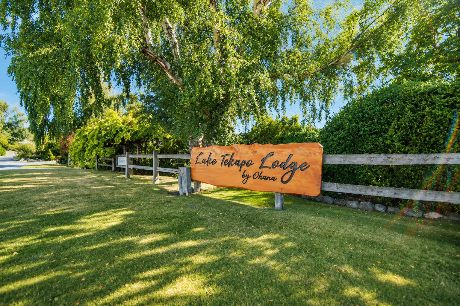 A wooden sign for Lake Tahoe Lodge by Ohana.