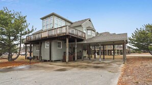 A two-story house with a balcony and a covered porch. - Cheven, Ships Watch Community in Duck, NC (Kitty Hawk)