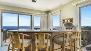 A balcony with wicker bar stools and a view of the ocean. - Hemmington, Ships Watch Community in Duck, NC (Duck)