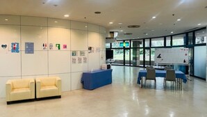 A spacious lobby with a reception desk, seating area, and a large window providing natural light. - Hotel Tetora Resort Shizuoka Yaizu (Yaizu)