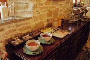 A breakfast buffet with various food items and condiments. - AURORA-INN (Volos)