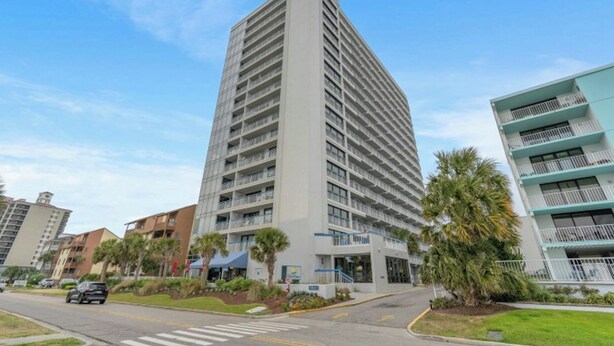 A tall, modern hotel with multiple floors and balconies. - Forest Dunes 207 -1BR -Pools, Hot Tub, Lazy River (Myrtle Beach)