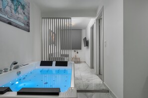 A modern bathroom with a large bathtub, a shower, and a vanity.