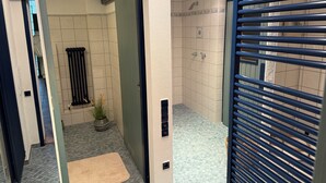 A modern bathroom with a shower, a radiator, and a potted plant. - Cozy - Guest room (Notzingen)