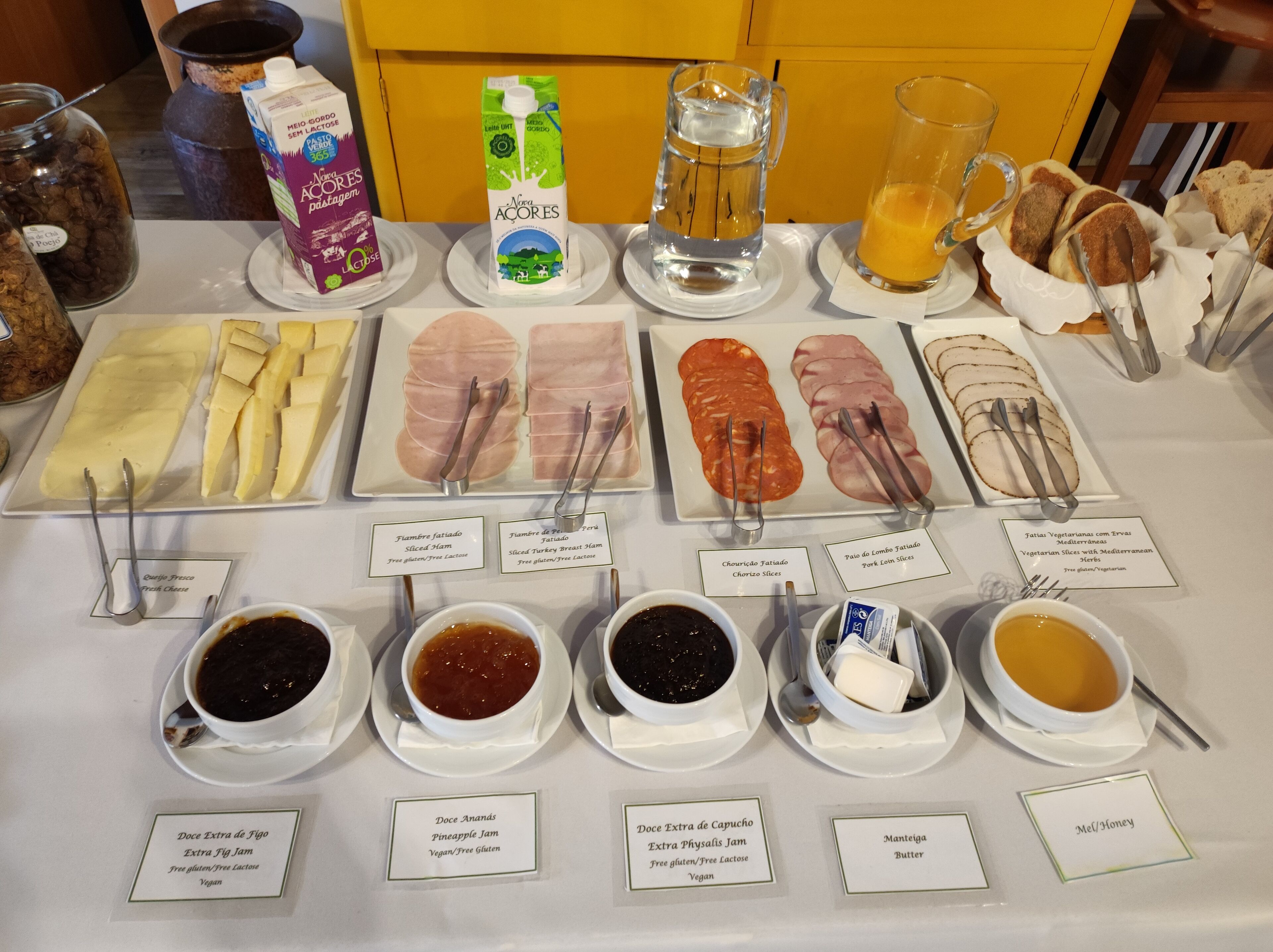 A buffet with various food options including meats, cheeses, and condiments.