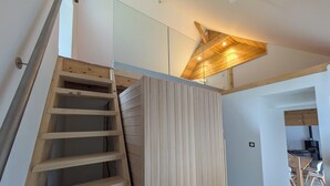 A wooden staircase with a modern design, leading to an upper floor.