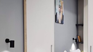 Ein modernes Schlafzimmer mit Bett, Nachttisch und Spiegel.