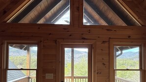 A wooden cabin with a sloped roof, a central door, and two windows on either side. - Gorgeous Cabin Private Retreat on 15 acres (Copperhill)
