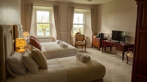 A hotel room with two beds, a desk, a television, and a chair. - Hill House – Luxury Group Getaway with Stunning Views, Sleeps 17 (Cashel)