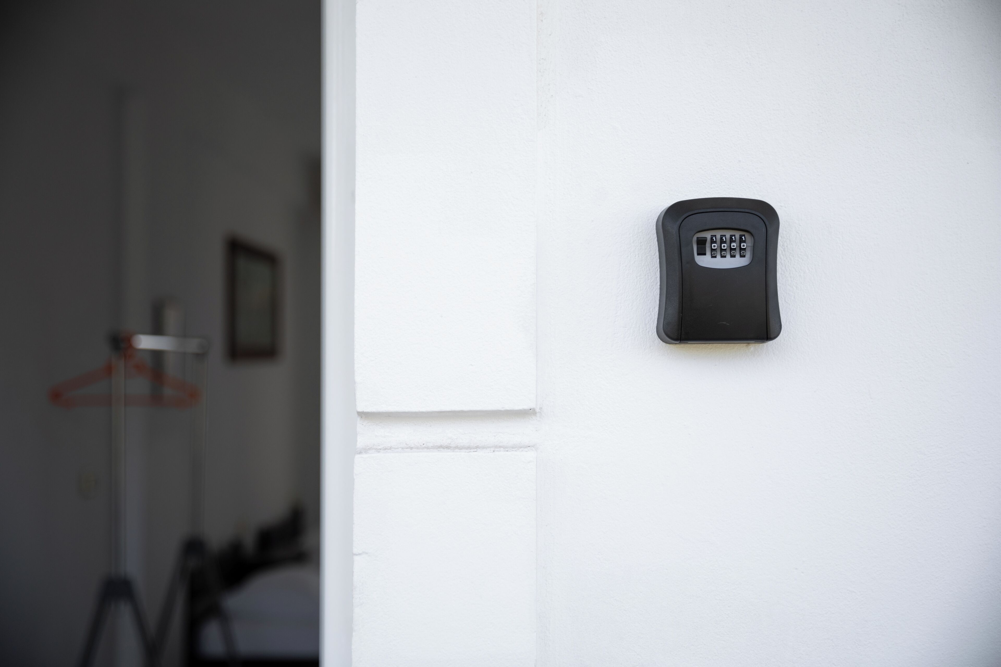 A wall-mounted electronic keypad, likely for room access, on a white wall.