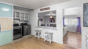 A compact kitchen with modern appliances, a dining area with a view, and a cozy seating area. - Spacious 3bd 2 bath home in Ruby hill (Denver)