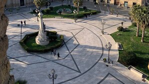 A plaza with a central fountain, surrounded by buildings with traditional architecture. - Tower of Bassano Luxury Room (Vasto)