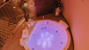 A hot tub with a control panel, a towel, and a decorative vase. - Tower of Bassano Luxury Room (Vasto)