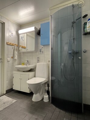 Enjoy a refreshing shower in this bathroom with a walk-in shower, glass door, and handheld showerhead.