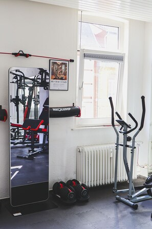 A gym with exercise equipment, a window, and a radiator. - 🎮Gamer's Lair🕹 incl. Extras (Göttingen)
