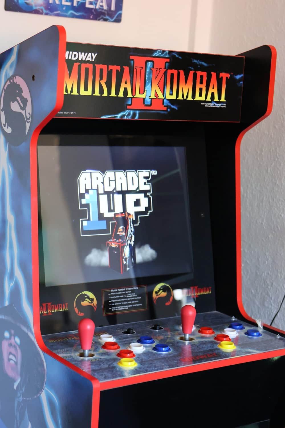 A Midway arcade machine with Mortal Kombat II and Arcade 1UP titles.