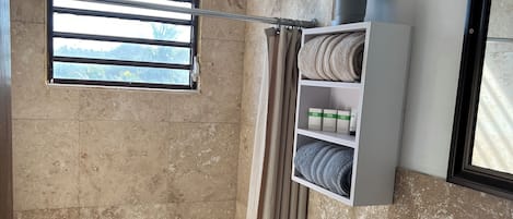 Un baño con ducha, inodoro y lavamanos.