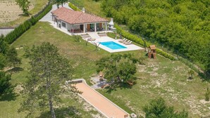 A house with a swimming pool, a patio, and a slide.