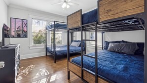 A bunk bed room with a desk and a window with blinds. - Family Getaway Near Zoo & Downtown Fun! Sleeps 10 (Atlanta)