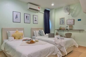 A hotel room with two beds, an air conditioner, a fan, and framed artwork on the walls. - NewWALAI N3 Landed house near IMAGO KK CarGarage (Kota Kinabalu)