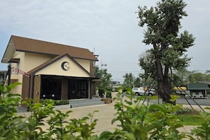 A building with a brown roof and a sign with a crescent moon and stars.