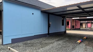 A building with a blue exterior and a covered outdoor area.