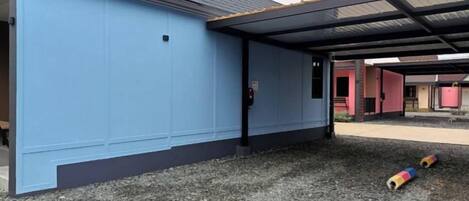 A building with a blue exterior and a covered outdoor area.