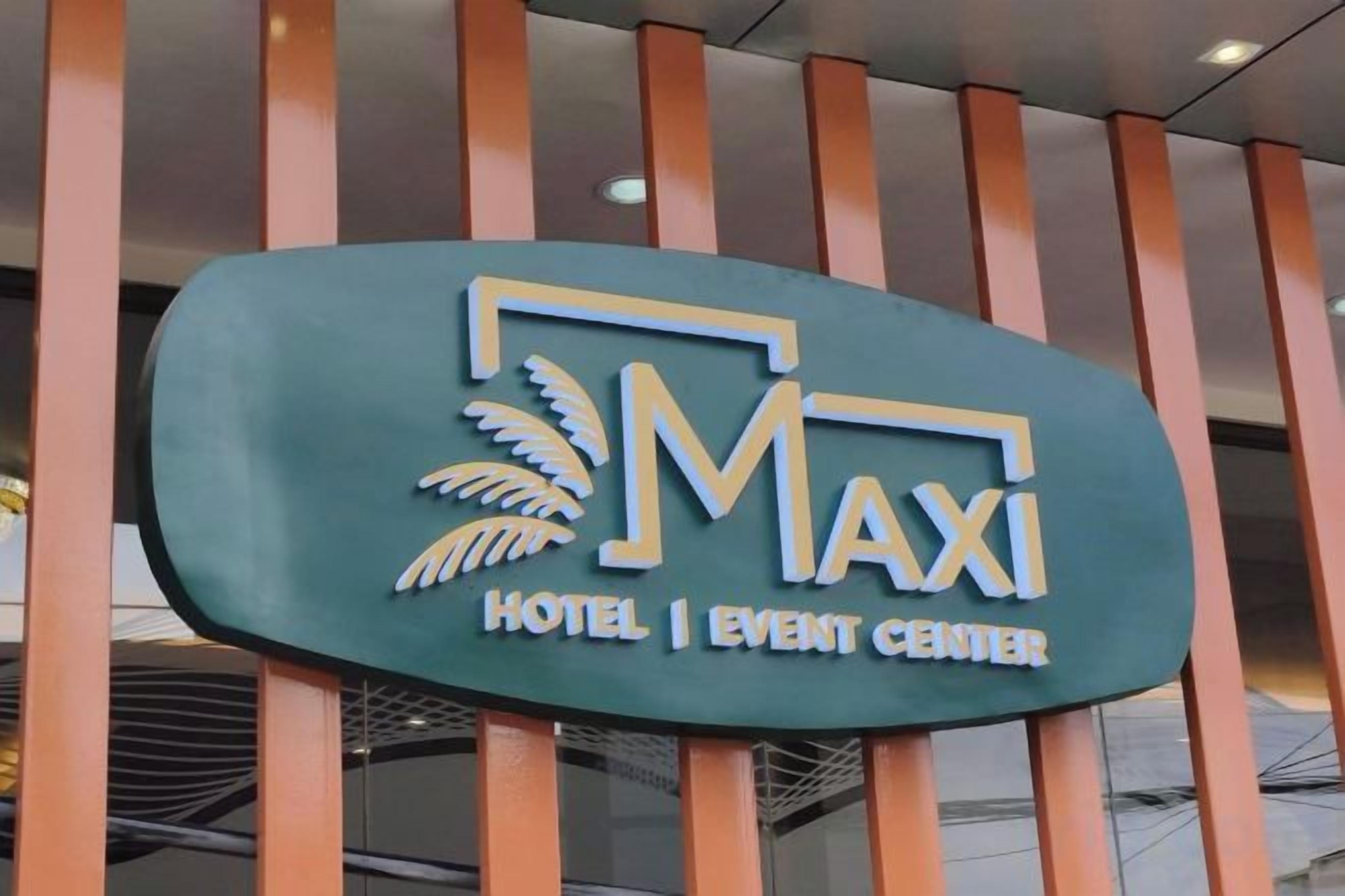 A sign for the Maxxi Hotel & Event Center.