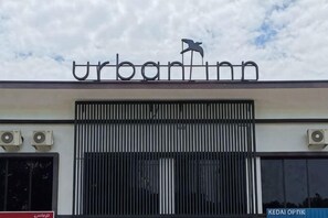 A building with a sign reading 'urban inn' and a bird logo above the entrance. - Urban Inn Salak Tinggi (Sepang)