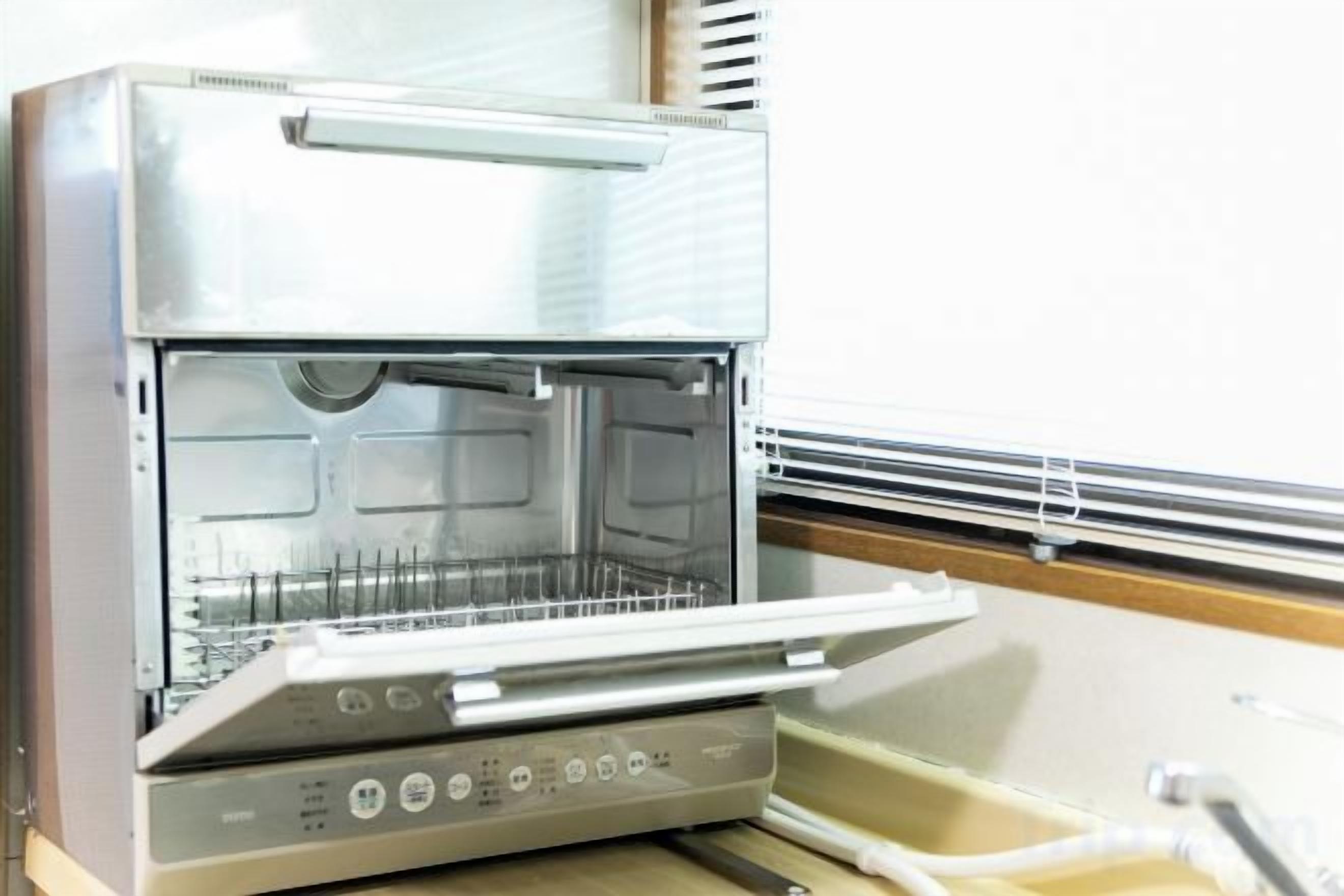 A commercial kitchen with stainless steel appliances, including a large oven and a food preparation area.