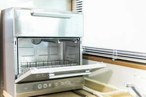 A commercial kitchen with stainless steel appliances, including a large oven and a food preparation area. - Awaji egaosakuie in Sumoto (Sumoto)