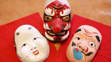 Three masks on a red cloth.