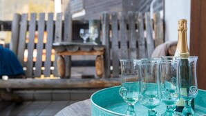 A table with a bottle of champagne and several glasses on a tray. - Villars Soleil B 13/14 by Interhome (Villars)