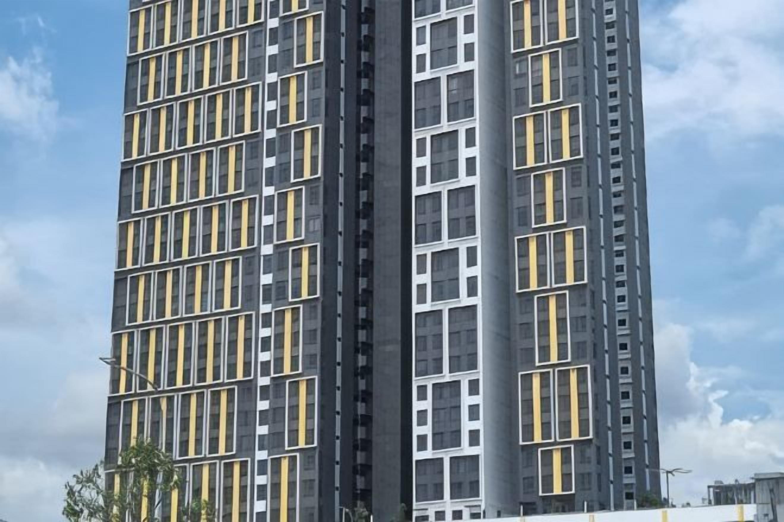 A high-rise building with a grid-like facade and multiple windows.