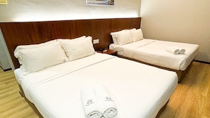 A hotel room with two beds, each with white linens and towels. - EMART HOTEL RIAM SDN BHD (Miri)