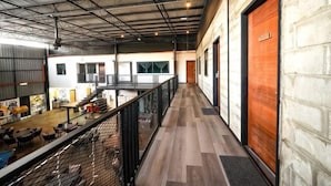 A spacious industrial-style building with a long corridor, large windows, and a high ceiling. - Peaceful Cottage (Semporna)