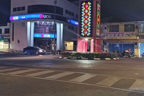 A UOB building with a prominent entrance, a parking area, and a nearby Ez Paradise shop. - Wisma Orchid Homestay Tuaran (Tuaran)