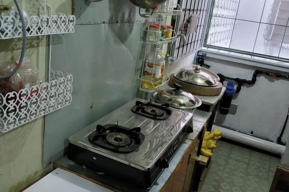 A kitchen with a gas stove, a sink, and a window.