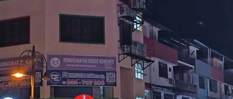 A building with multiple floors and commercial signage, including a visible credit union and a business named 'Impiat'.